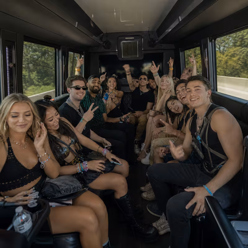 Group boarding a white charter bus for Concert Transportation transportation in Fremont
