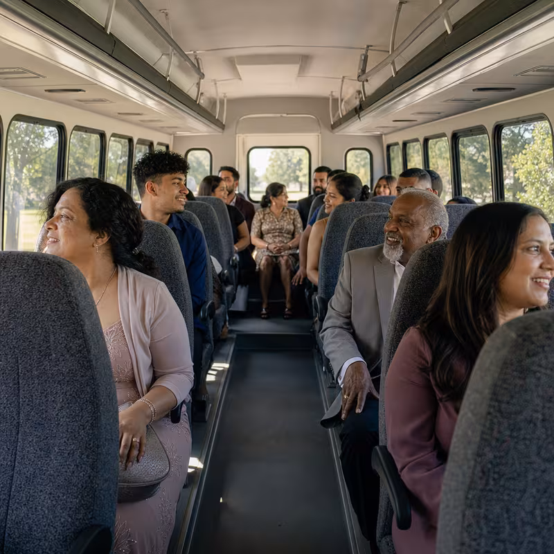 Group boarding a white charter bus for Private Event Transportation transportation in Fremont