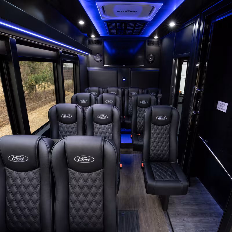 Party bus interior with wraparound leather seating and LED lighting in Fremont
