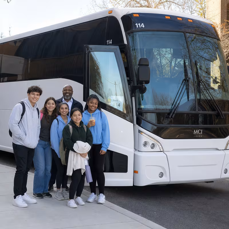 Passengers loading luggage while boarding an Fremont group shuttle