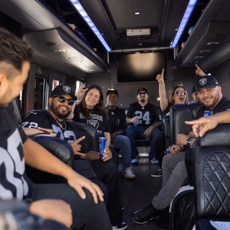 Group boarding a white charter bus for Sporting Event Transportation transportation in Fremont