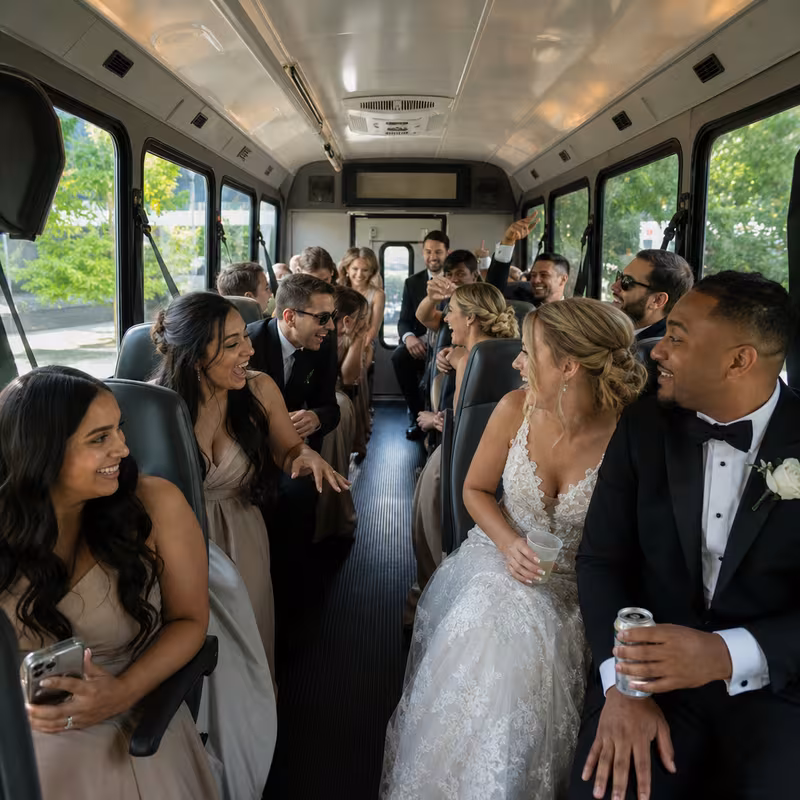 Group boarding a white charter bus for Wedding Transportation transportation in Fremont